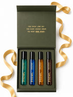 Top-down view of an open PROWL Perfume Discovery Set box featuring four perfume vials, surrounded by a loose gold ribbon.