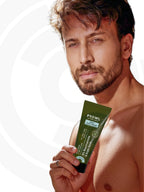 Shirtless Tiger Shroff looking forward holding a tube of PROWL Daily Face Cream.