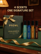 Four PROWL perfume vials standing next to a closed, ribbon-tied Perfume Discovery Set box on a green pool table.